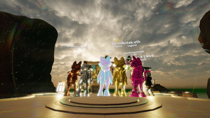 A screenshot from a 3D virtual world game showing several diverse, colorful avatars standing together on a circular platform under a cloudy sky, with floating usernames like 'redmontj...jmc', 'Bones4vitek.eth', and 'blackcoated81' above them.