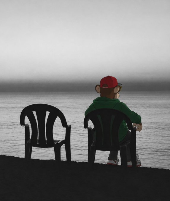 A silhouette of an animated character wearing a red cap and green hoodie sitting in a black plastic chair, looking out at a foggy body of water next to an empty chair.