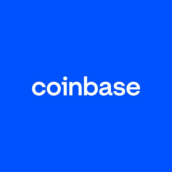 The image features the word "coinbase" in white lowercase text centered on a solid blue background. This relates to the post about Coinbase launching tokenized stocks of Apple and Nvidia on its Base network, allowing users to trade these stocks directly from their crypto wallets.