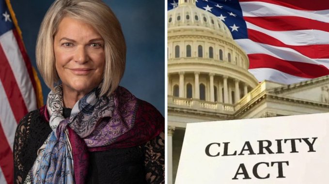 Senator Cynthia Lummis appears in an official portrait alongside the U.S. Capitol building, an American flag, and a document labeled "CLARITY ACT," visually tying the lawmaker to the long-awaited crypto regulatory legislation she has championed for nearly a year.