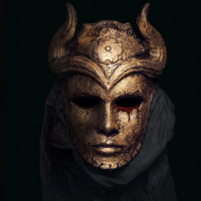 A golden horned mask with a blood-red tear dripping from its left eye, evoking a sense of dark sorcery. The image aligns with the post's promotion of a Telegram channel for crypto trade calls, suggesting an element of secrecy or hidden insight behind the mystical, ominous visage.