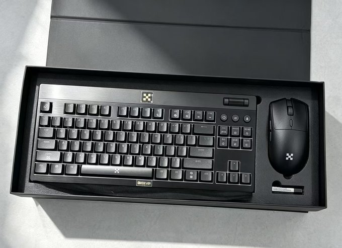 The image shows a black keyboard and mouse set in a sleek box, featuring the OKX logo and branding, which connects to the post about an OKX VIP event where a woman trades ETH on the OKX platform.