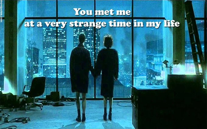 Two silhouetted figures holding hands stand before a large window overlooking a blue-lit cityscape, with the text overlay 'You met me at a very strange time in my life.'