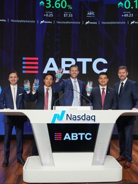 Five men in suits pose with raised champagne glasses at the Nasdaq podium during ABTC's first anniversary as a publicly listed company, with screens in the background showing the ABTC ticker at $7.31 (+3.60%). The image captures the milestone celebration referenced in the post, commemorating American Bitcoin's Nasdaq listing milestone with its substantial Bitcoin holdings and mining operation.
