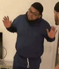 The image shows a man wearing glasses, a blue hoodie, and sweatpants standing against a white wall with his arms outstretched as if he's making an exaggerated gesture or posing for a photo. The caption of the image reads "we are getting to the point where you should be questioning every large name influencer who loudly supported $ZEC and if you think they - Authentically supported it? OR - got paid to do so...", which seems unrelated to the man in the picture but could potentially be a reference to the recent trend of people making funny or exaggerated gestures on social media.