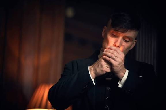 The image shows a man lighting a cigarette, perhaps reflecting on the volatile crypto market where $BTC reached $79k and millions in longs and shorts were liquidated.