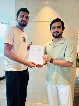 Two men proudly hold up a certificate together, celebrating the successful completion of the Blockchain Bootcamp hosted by RedotsClub Pakistan and Creator's Con Pakistan in Islamabad, which covered topics like Web3, blockchain, crypto, forex, and trading.