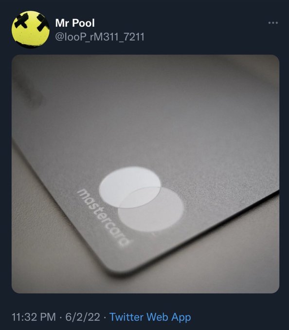The image shows a close-up of a Mastercard credit card, which has a white background with two circles representing the company's logo. Below the credit card, there is text that reads "Close Enough #XRP". The post appears to be a social media post or tweet, as indicated by the presence of the hashtag "#XRP" and the Twitter web app's name in the caption.