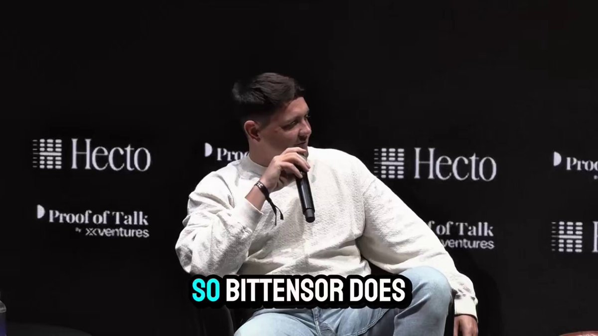 iced coffee cup with "So Bitten" text on a black background, accompanied by a man seated at a table and a white banner reading "HECTO" and "PROOF OF TALK".