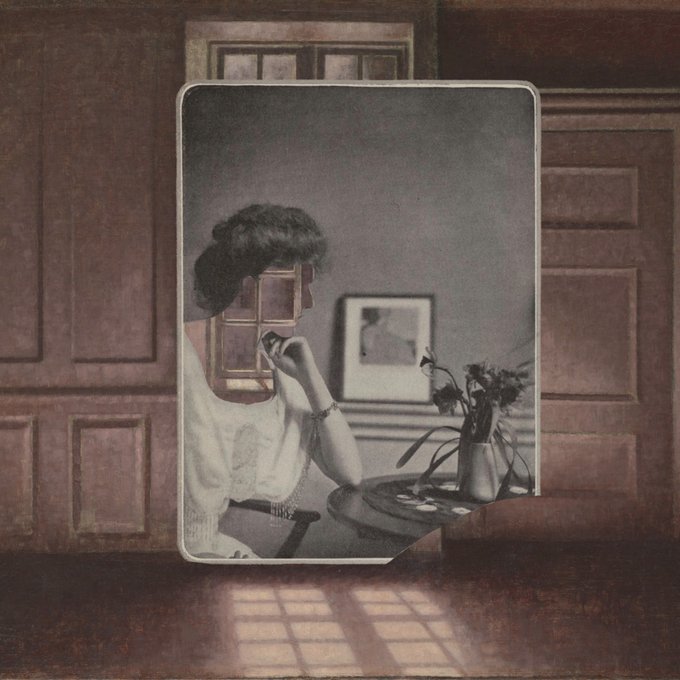 A vintage-style mirror photograph showing a reflection of a woman with short dark hair sitting at a table with flowers and a vase, with a four-pane window reflected over her face.