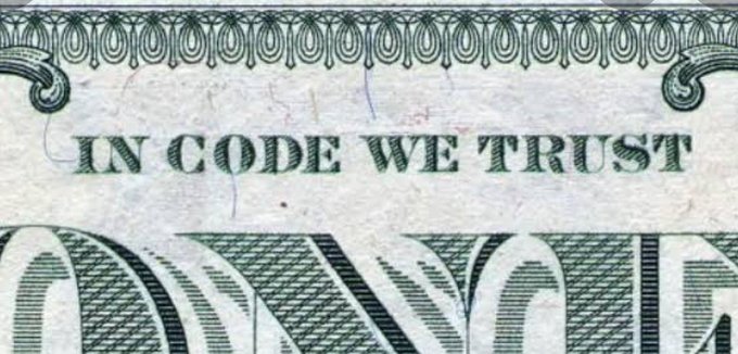 The text "IN CODE WE TRUST" is printed in green on a close-up of U.S. currency.