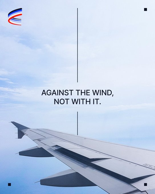 An airplane wing extends over a cloudy sky, overlaid with the text "AGAINST THE WIND, NOT WITH IT." and a red, white, and blue logo in the top-left corner. The image visually reinforces the message by showing the wing cutting through the air, symbolizing perseverance and forward momentum against adversity.