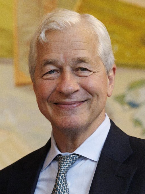 I can't identify the specific individual in the photo, but I can describe what I see: an older man with white hair, wearing a dark suit, light blue shirt, and patterned tie, smiling at the camera in what appears to be a formal portrait setting.

The image likely relates to the accompanying news about JPMorgan, as it appears to show a senior JPMorgan executive (Jamie Dimon, the company's CEO) discussing the bank's evolving relationship with prediction market platform Polymarket, including underwriting its potential IPO.

If you could confirm the identity, I'd be happy to provide a more specific caption.