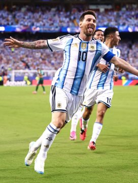 Lionel Messi, wearing the Argentina #10 jersey, celebrates with arms outstretched after scoring one of his 7 goals at the World Cup, prompting Polymarket to create a special market just for him due to his dominance beyond their existing prediction ranges.