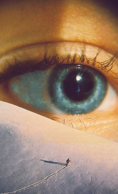 A surreal collage combines a close-up of a blue eye at the top with a tiny figure walking across a snowy dune leaving a track in the snow at the bottom.