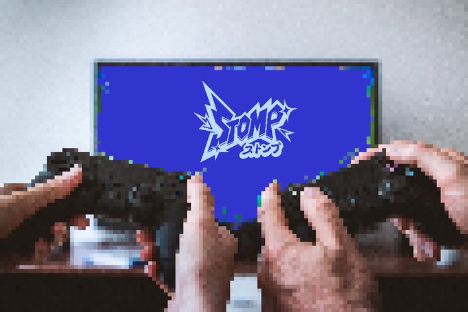 A pixel-art style image shows two hands holding black game controllers in front of a blue screen displaying a white logo that reads 'STOMP' with Japanese characters beneath it.
