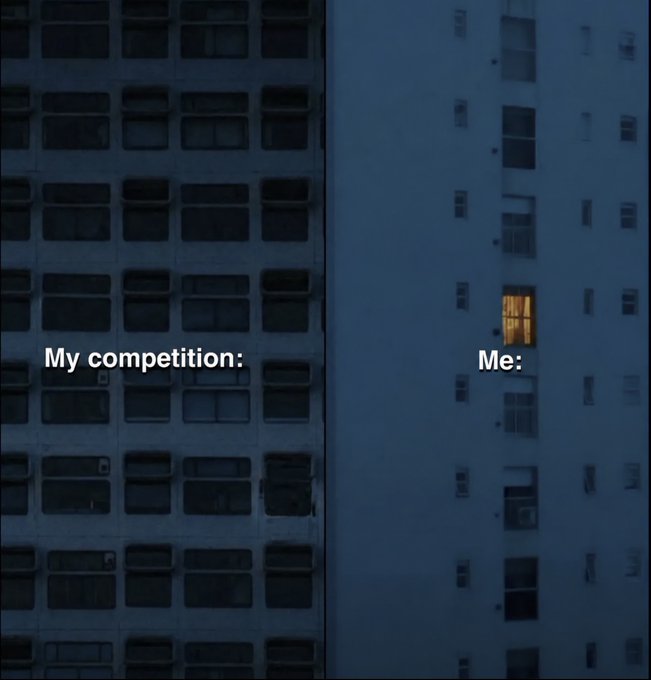 A dimly lit nighttime view of two high-rise buildings contrasts a large, mostly dark skyscraper labeled "My competition:" with a tall building labeled "Me:" featuring a single illuminated window. The single lit window amid the darkness visually represents the caption "Locked in," suggesting intense solo focus or late-night dedication to work or study.