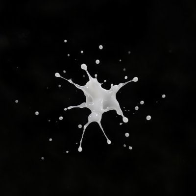 An artistic image of a white liquid splash or splatter against a black background.