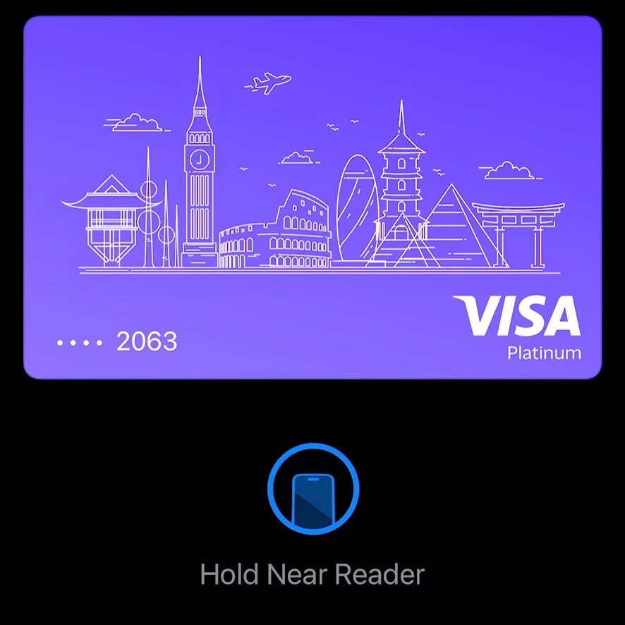 The image shows a purple Visa credit card with a city skyline design, including the Eiffel Tower and Big Ben, printed on it. The text "hold near reader" is displayed below the card, indicating that the user can hold their card near a mobile device for a Near Reader feature to access information about the card or make purchases.