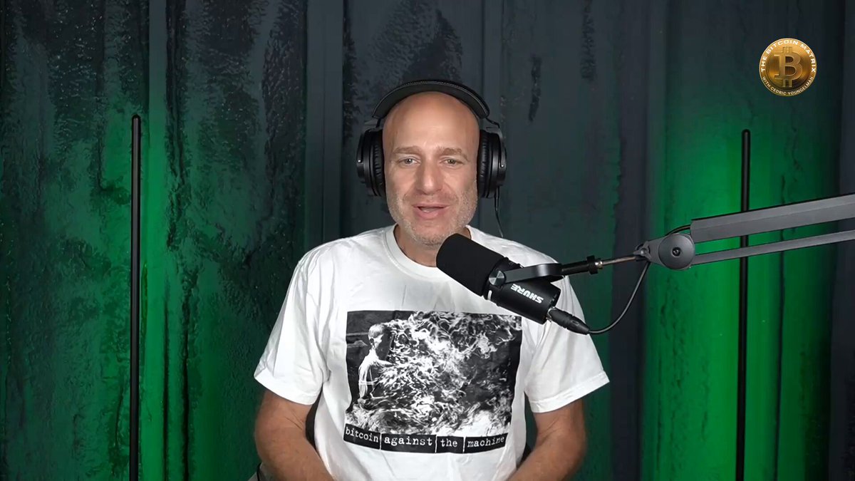 The image features a man wearing headphones and sitting behind a microphone while talking into it. The background of the image has green lighting that makes him stand out, and there are two black poles visible in the scene as well. The caption for the image reads "Huge thanks to @firefish_io for powering the show. Non-custodial Bitcoin-backed loans. Your keys stay in multisig the whole time. Don' sell your Bitcoin, live off it. Get started at firefish.io with code MATRIX".