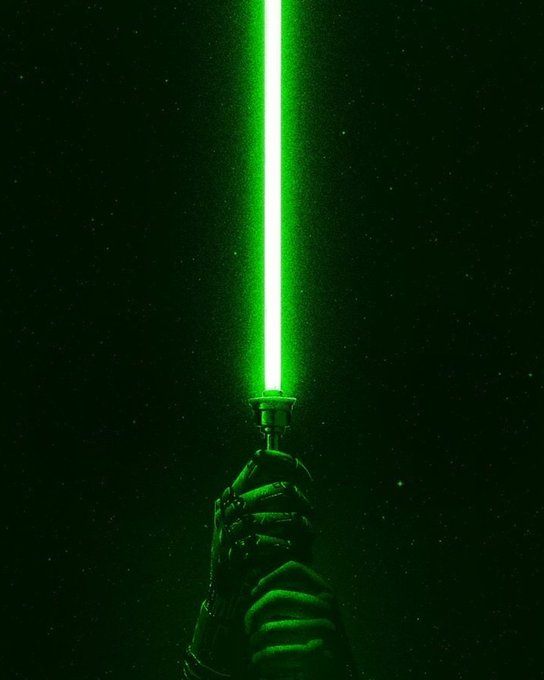 A gloved hand holding a glowing green lightsaber against a dark, starry background.