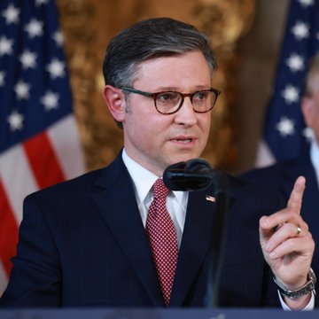 Speaker of the House Mike Johnson (R-LA) speaks at a podium with American flags in the background, gesturing with his finger raised as Republicans brace for a likely Senate defeat of the Crypto Clarity Act next week—a blow that could shake crypto confidence given Johnson's leadership role in pushing the bill through the House.