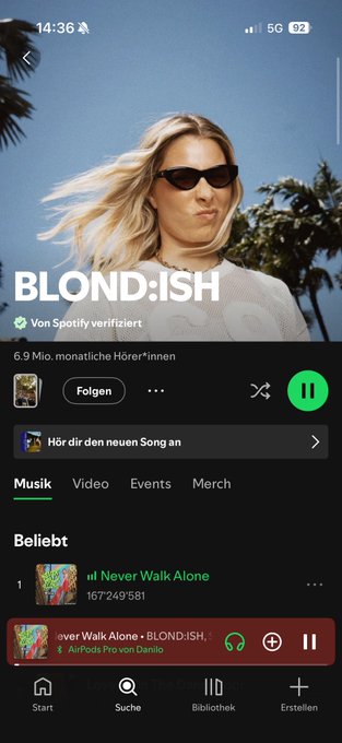 A Spotify artist page for BLOND:ISH showing 6.9 million monthly listeners, with the song 'Never Walk Alone' playing and the AirPods connected to Danilo.