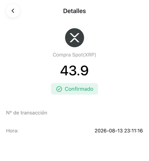 A mobile app screen displaying transaction details in Spanish: 'Compra Spot(XRP)' for 43.9 XRP, marked as 'Confirmado' (Confirmed), with a transaction time of 2026-08-13 23:11:16.