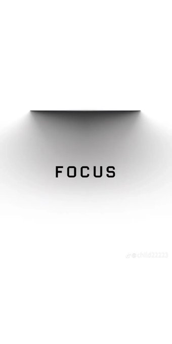 A minimalist design featuring the word 'FOCUS' in black text illuminated by a single spotlight shining down from the top against a dark ceiling, with a watermark '@child212121'.