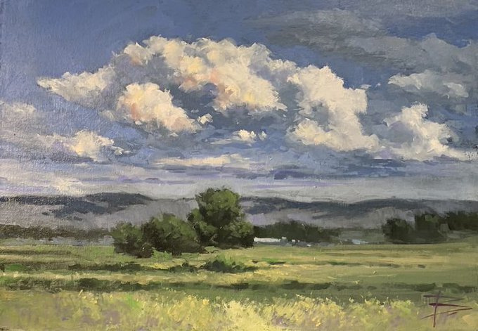An oil painting landscape features a vast green field with a cluster of dark trees in the middle ground, distant blue mountains, and a sky filled with large, puffy white and gray clouds.