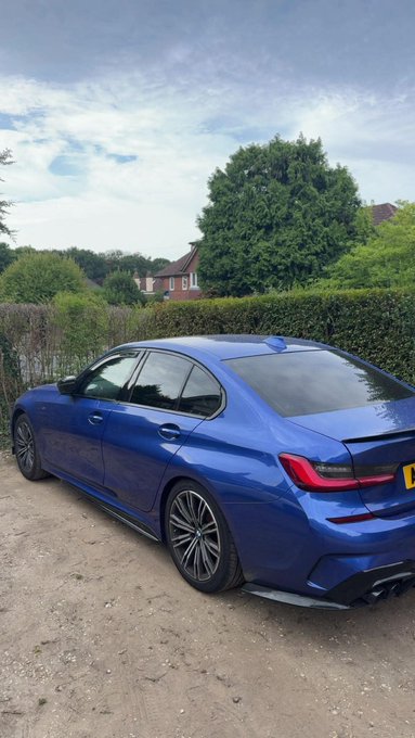 The image shows a blue BMW sedan, possibly a 3 Series, with a license plate that starts with "AE". The post thanks Solana, implying the car may be a purchase or reward associated with the Solana cryptocurrency, perhaps through a promotion or as a high-value exchange.