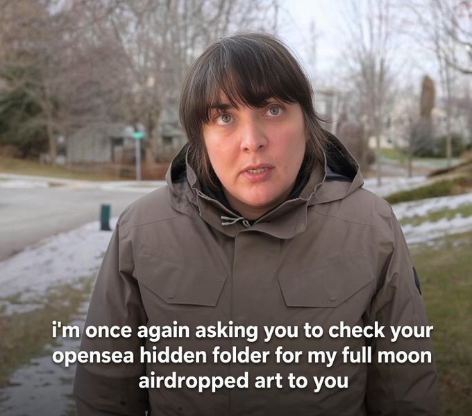 A woman in a winter jacket standing outdoors in a meme format with the caption 'i'm once again asking you to check your opensea hidden folder for my full moon airdropped art to you'.
