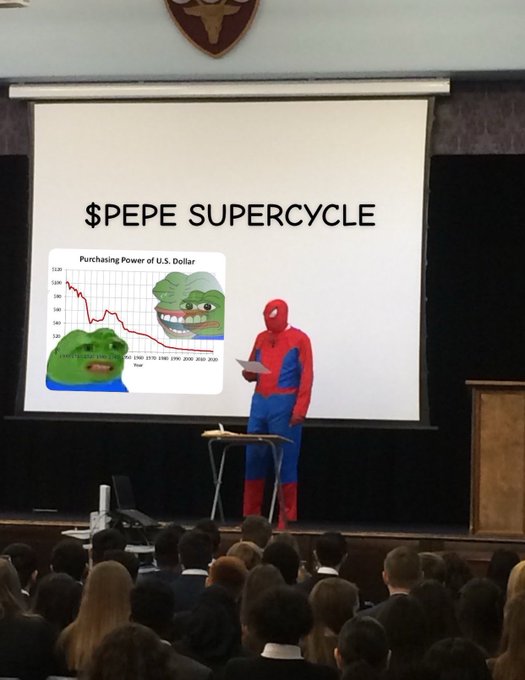 A person in a Spider-Man costume presents at a school assembly, standing in front of a projection displaying "$PEPE SUPERCYCLE" alongside a "Purchasing Power of U.S. Dollar" chart featuring Pepe the Frog memes. The image humorously illustrates the "brand new day $pepe" sentiment, using the dressed-up speaker and frog imagery to playfully reference the PEPE cryptocurrency's bullish outlook amid declining dollar purchasing power.