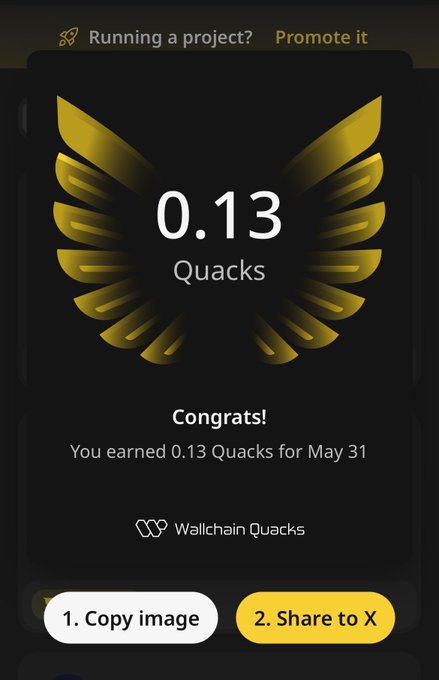 The image shows an app screen with a gold-colored logo featuring a bird's wing design, along with some text that reads "0.13 Quacks" and "congrats! You earned 0.13 Quacks for May 31". The background of the image is black, making it stand out against the white space around it.