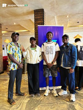 Four young men pose together at what appears to be a SolEcoCall event, with the "superteam" Nigerian flag logo visible in the top left corner and the number "20" visible in the background, highlighting the gathering of builders and collaborators in the Solana ecosystem.