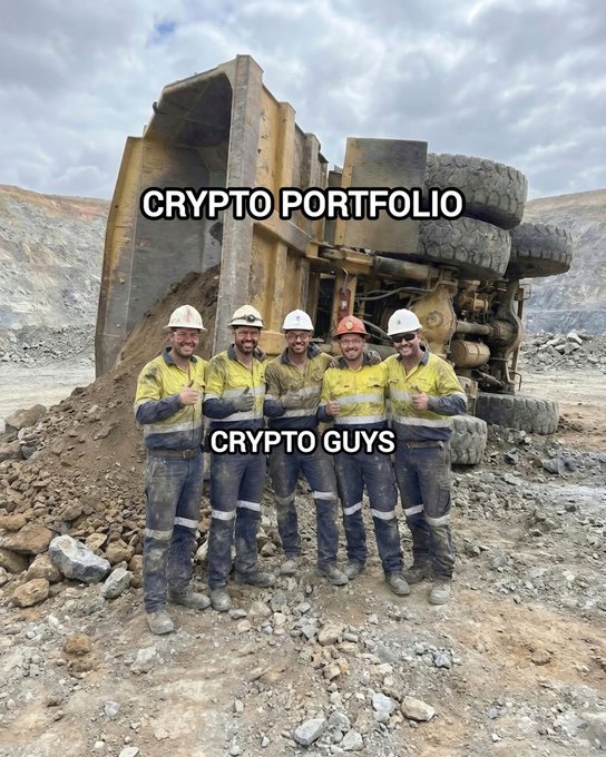 A meme showing five miners in safety gear giving thumbs up in front of a tipped-over mining dump truck, labeled 'CRYPTO PORTFOLIO' on the truck and 'CRYPTO GUYS' on the men.