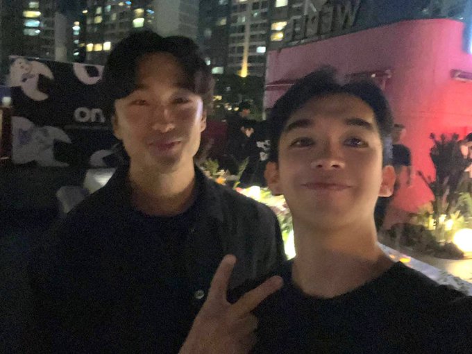 Two smiling young men pose for a selfie at a nighttime rooftop event, with city high-rises and event signage reading "WEB3" and "on" visible in the background, matching the celebratory tone of the post about a joint event with KAST, Pudgy Penguins, and FOMO.