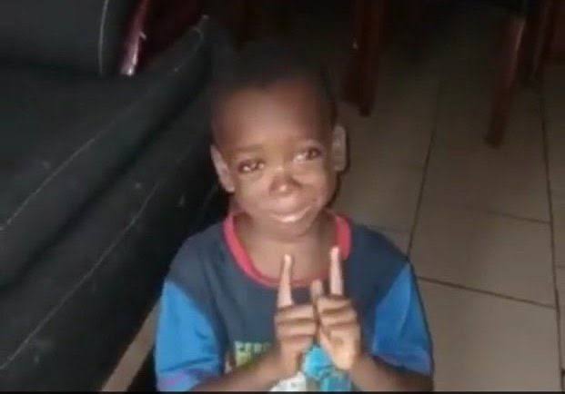 The image shows a young boy with black hair, wearing a blue shirt, making two thumbs up signs as if he's giving a thumbs up or expressing approval. The caption of the image reads "x algo please stop showing us gm post once it' s 12 pm". This suggests that the image was taken at 12:00 PM and is related to an online discussion about a particular topic, possibly involving a game called "gm" (for "game mode").