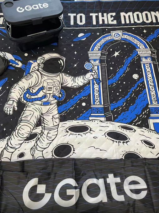 A picnic mat featuring a space-themed illustration with an astronaut, a gateway, and the moon, branded with 'Gate' and 'TO THE MOON' text.