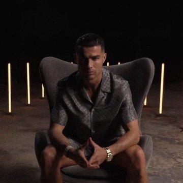 Cristiano Ronaldo sits in a dark setting with a serious expression, hands clasped, against a backdrop of glowing vertical lights, likely promoting the launch of his "$CR7" cryptocurrency presale mentioned in the accompanying text.
