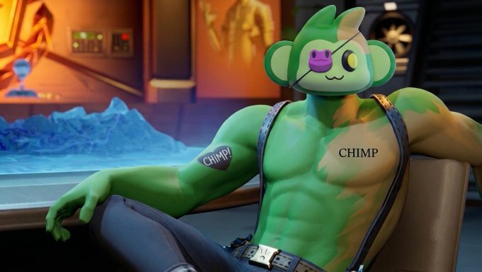 A muscular green cartoon monkey character labeled 'CHIMP' on its chest and bicep sits relaxed on a couch in an industrial setting, with the chimp holding a video game controller.