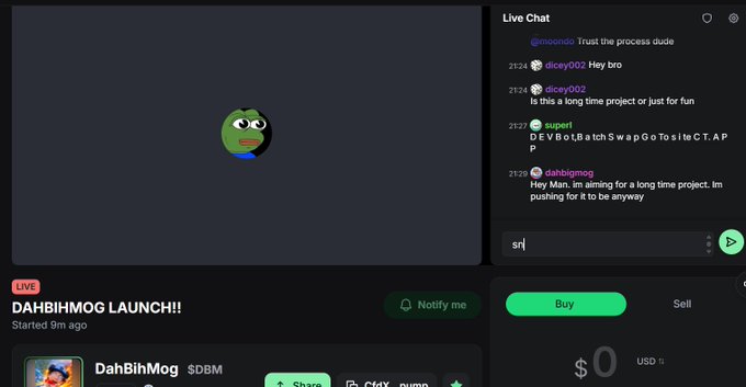 The image shows a computer screen with a cartoon frog character, possibly a frog or a frog monster, sitting at the bottom of the screen. Below this image, there are two tabs open - one labeled "Dah hummus launch!" and another tab titled "LIVE RIGHT NOW ON PUMPFUN!". The text on these tabs suggests that the viewer is about to start a new game or activity related to the cartoon frog character.