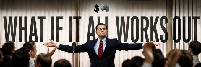 A man in a suit stands with arms outstretched before a crowd, beneath the bold text "WHAT IF IT ALL WORKS OUT" with a dollar sign and rocket emoji, embodying a rallying call to rebuild community after a crypto rug pull.