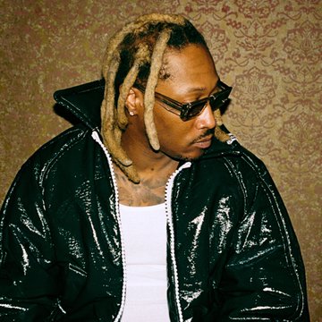The image features a man with blonde dreadlocks, dark sunglasses, and visible face tattoos, wearing a shiny black jacket against a patterned wallpaper background. He appears to be the rapper Future, to whom the post refers regarding his upcoming album "The Real Me" expected to top the Billboard 200.