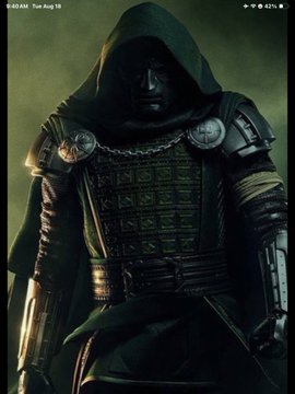 A smartphone screenshot showing a dark, armored figure in a hooded cloak with an obscured face, set against a green smoky background.