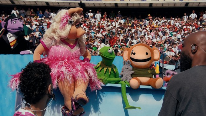 Miss Piggy, Kermit the Frog, and other Muppet characters perform on stage during what appears to be a World Cup halftime show in front of a packed stadium crowd. The image reflects the post's description of "bitcoin muppets" performing, though no Bitcoin branding or cryptocurrency references are visible in the scene itself.