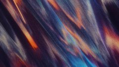 An abstract image featuring diagonal streaks of blue, red, and white colors blending together in a blurred, motion-like pattern.