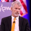 A bearded older man in a suit and yellow tie speaking at what appears to be a CPAC event, shown in a small cropped thumbnail.