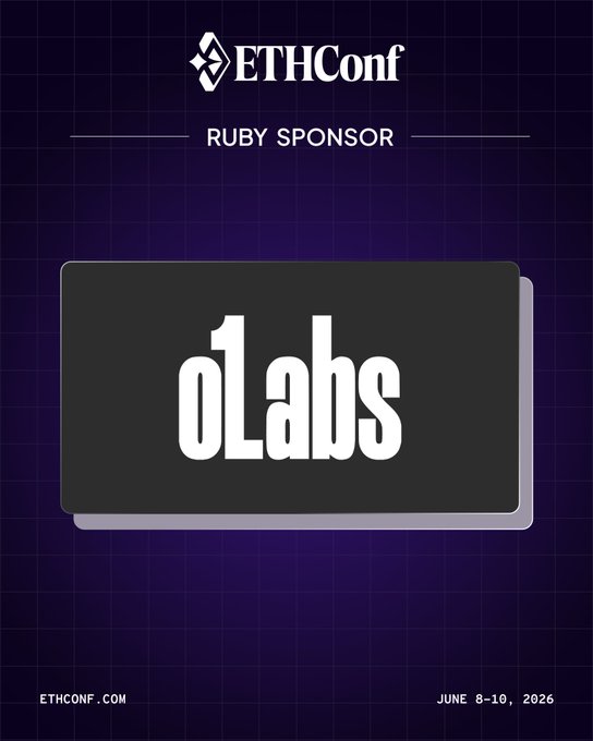 The image features a white rectangle with black text that says "oLabs" on it. The background of the image has a blue square pattern, which appears to be a grid with small squares. Below this rectangle, there's a smaller white rectangle containing some additional text that reads, "NYC friends: o1Labs is at ethcon com this week Catch @deepthiskumar8 on stage, then stop by booth to talk all things ZK, Mina, and what it takes to bring programmable cryptography into real-world use cases."