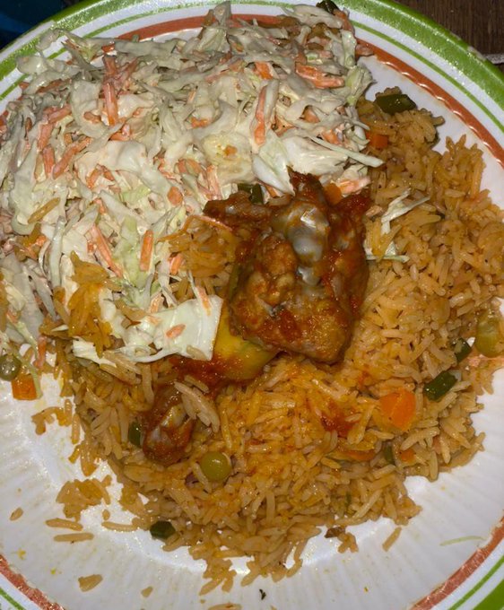 The image shows a plate of food consisting of rice, coleslaw, and meat (likely chicken). The plate has a green rim around its edge, giving it an appealing presentation. The photo appears to have been taken recently, as indicated by the watermark at the bottom that reads "happy weekend fam just minted this for 0.05 eth smash or pass?".